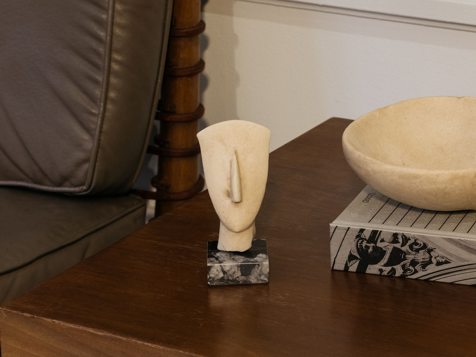 Cycladic head of a figurine made out of resin on a table