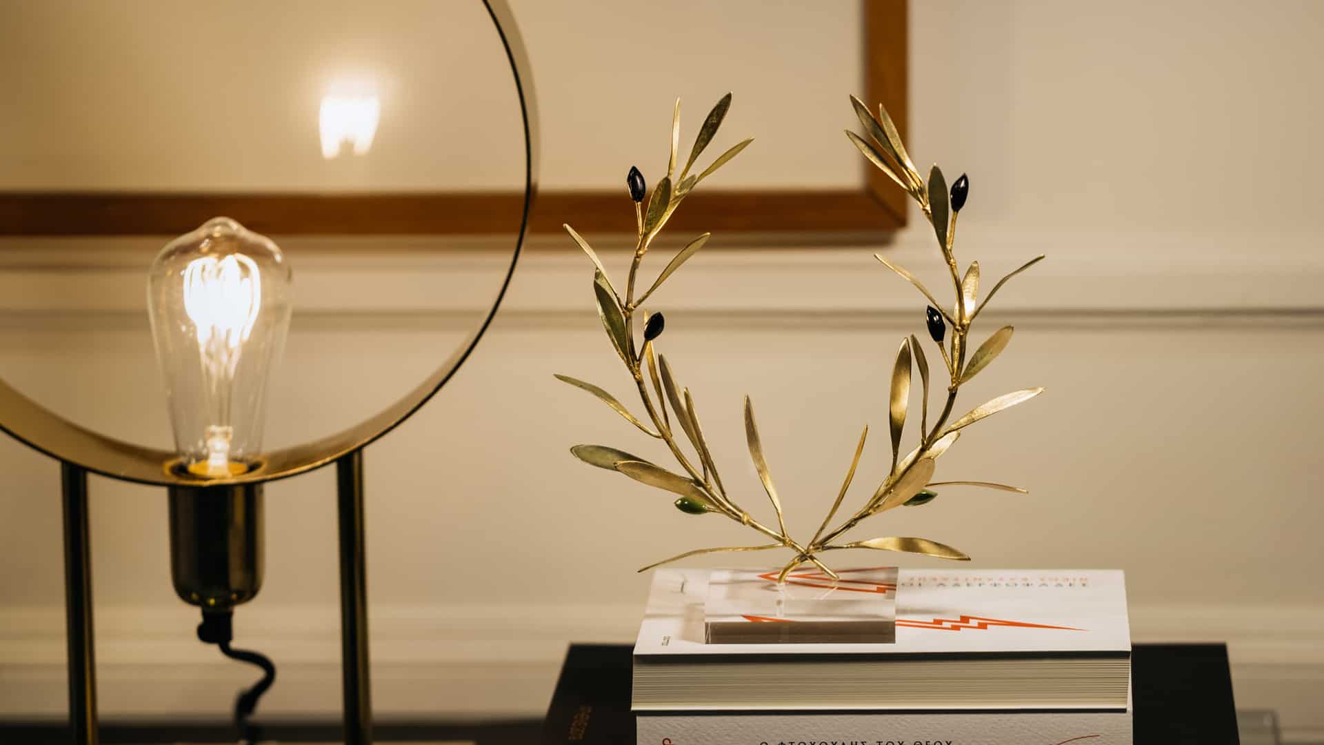 olive branch sculpture on books