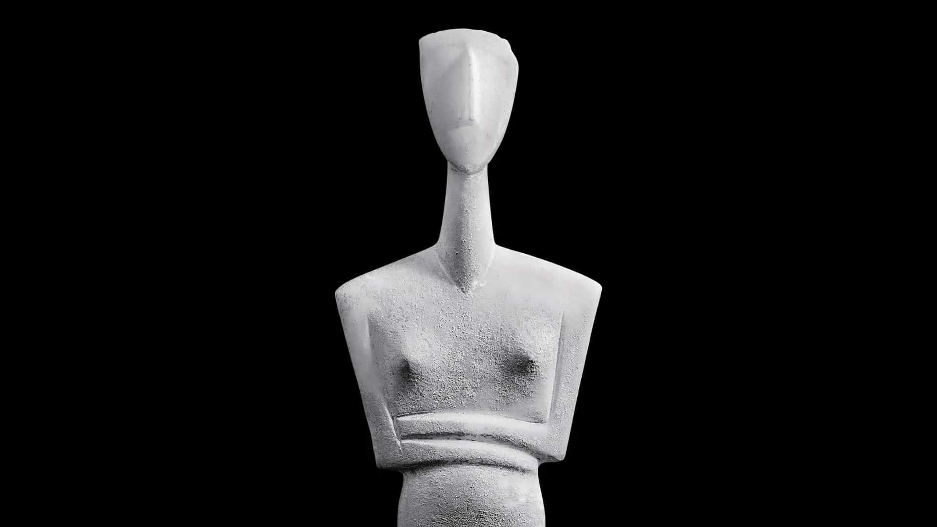 photograph of cycladic figurine torso on black background