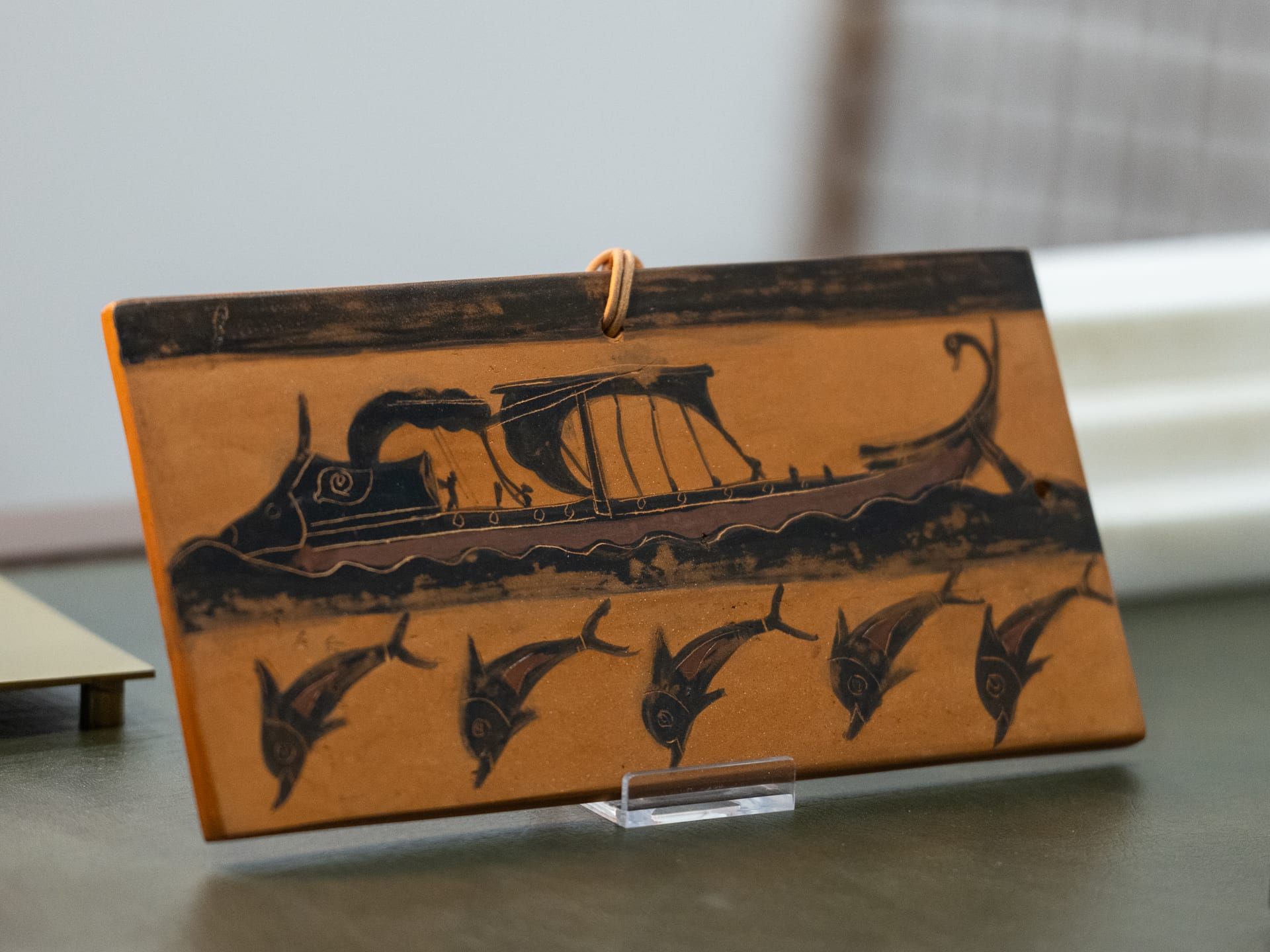 Ceramic Tile with a Depiction of a Ship and Dolphins