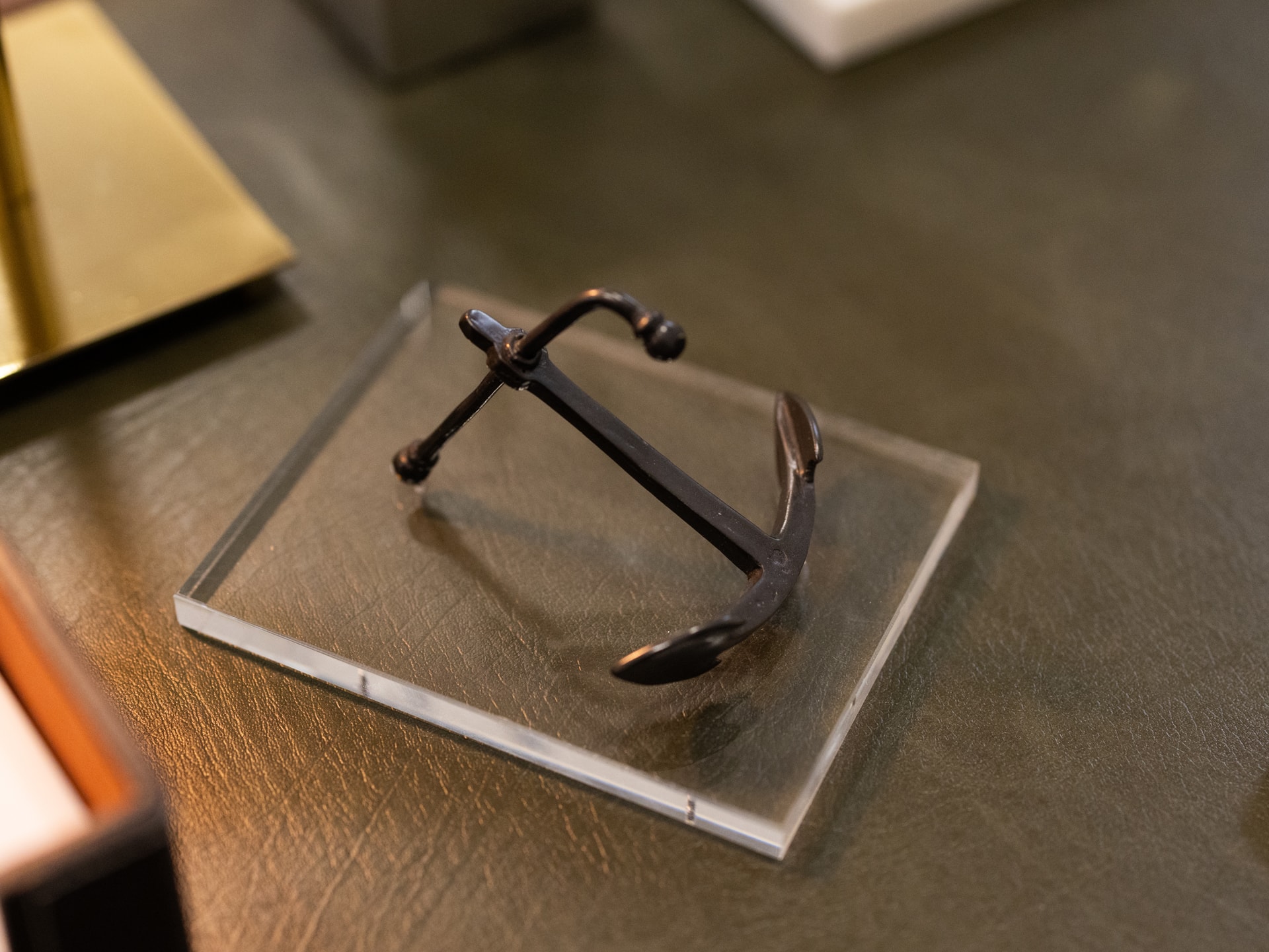 Decorative anchor on a plexiglass base.