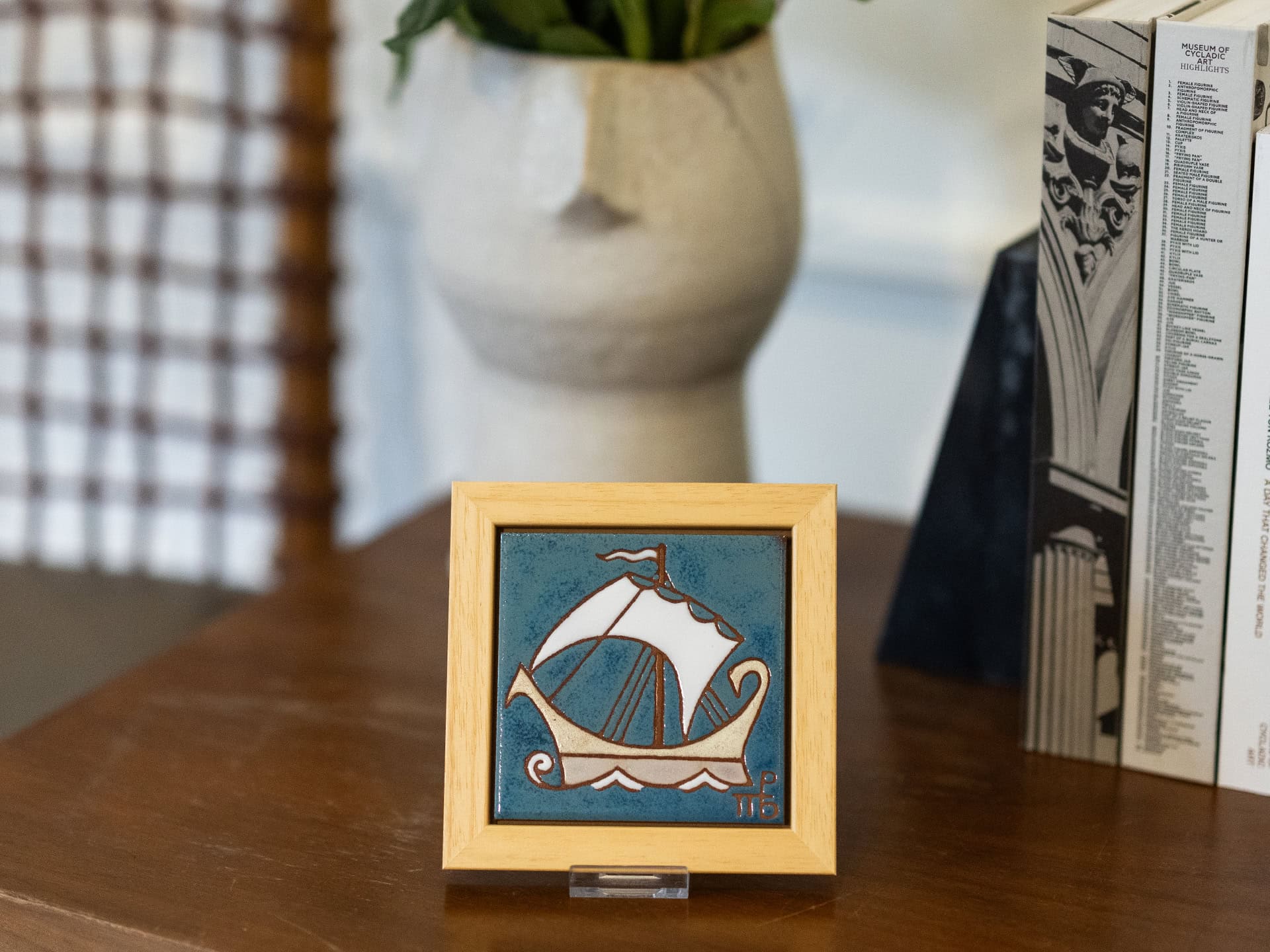 Handmade ceramic frame with a depiction of a ship.
