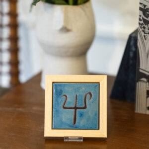 Handmade ceramic frame with a depiction of a trident.
