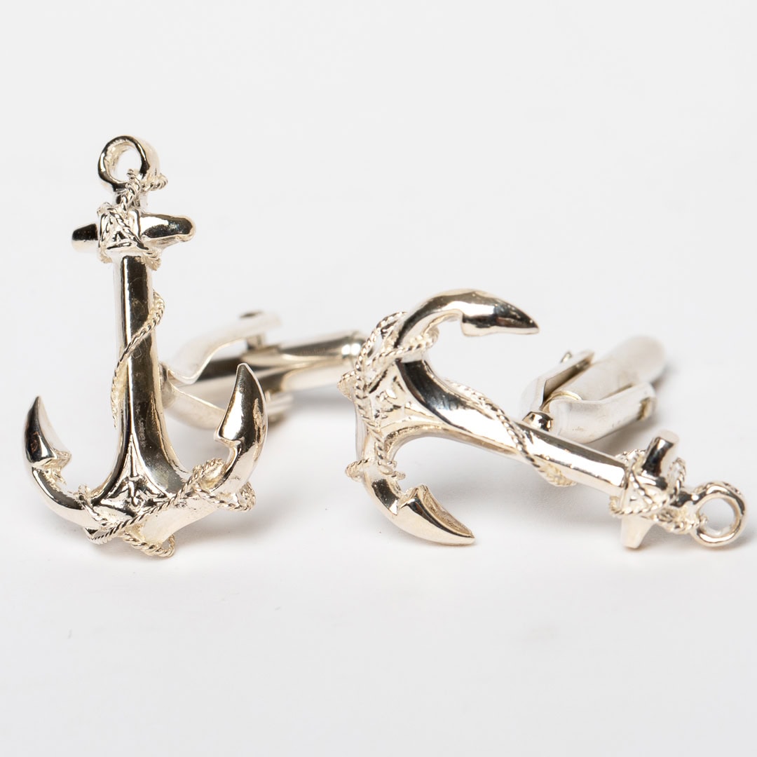 Silver cufflinks with anchors.