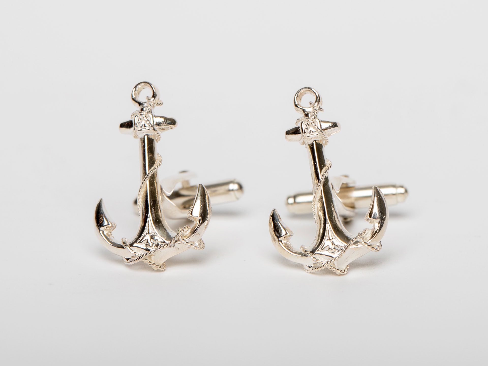 Silver cufflinks with anchors.